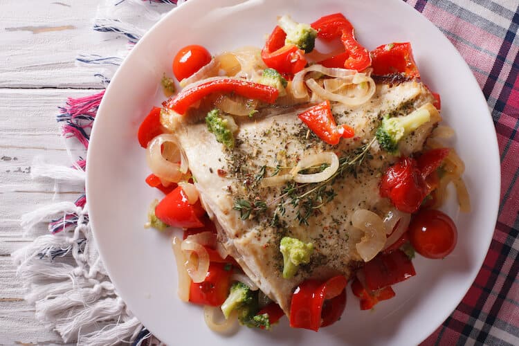Baked summer flounder served with a medley of vegetables.