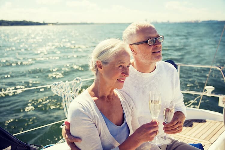 Senior ocuple enjoying the warm summer day by taking a boat ride.