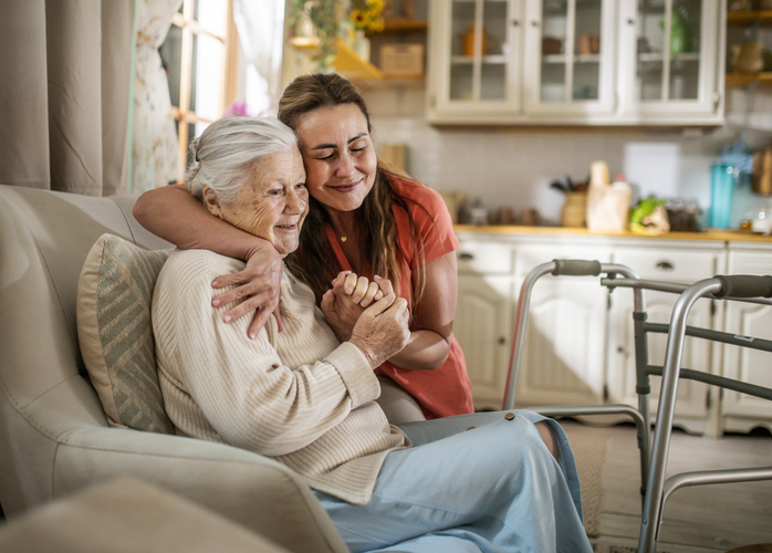 daughter Assisting Senior Woman with Walker at home