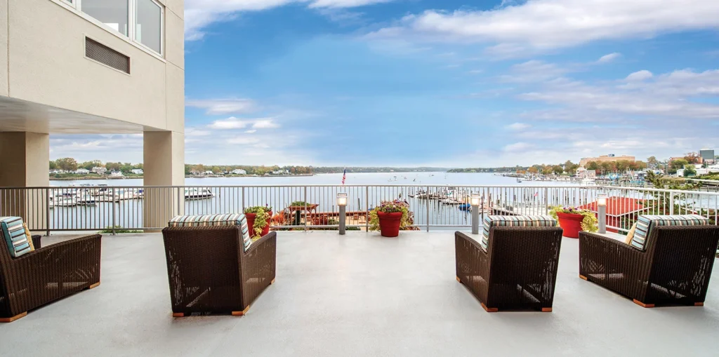 Two side by side chairs on a deck looking over the Harbor