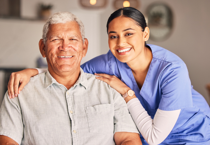 Senior man with caregiver smiling together