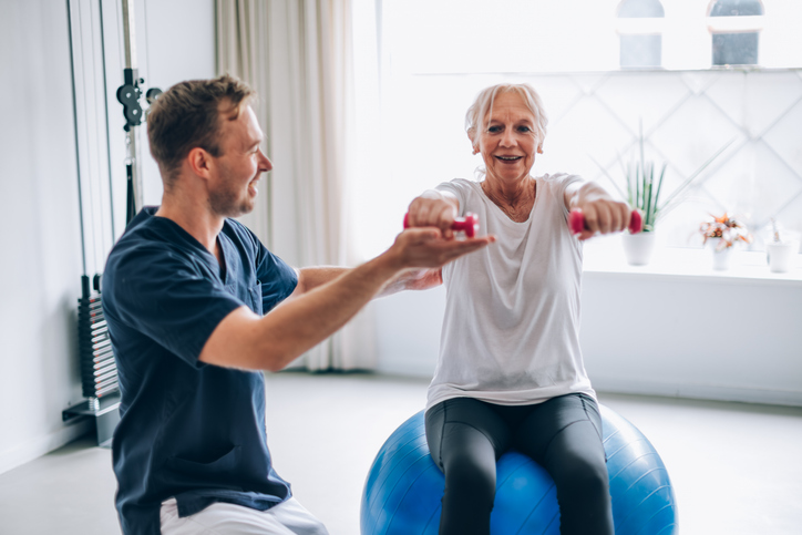 Older Women with a Therapist doing rehabilitation exercise