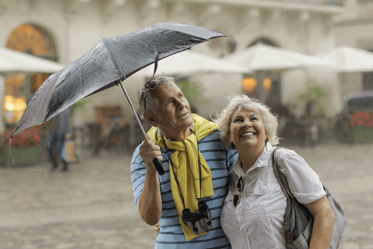 A senior husband and wife enjoying sightseeing while traveling.